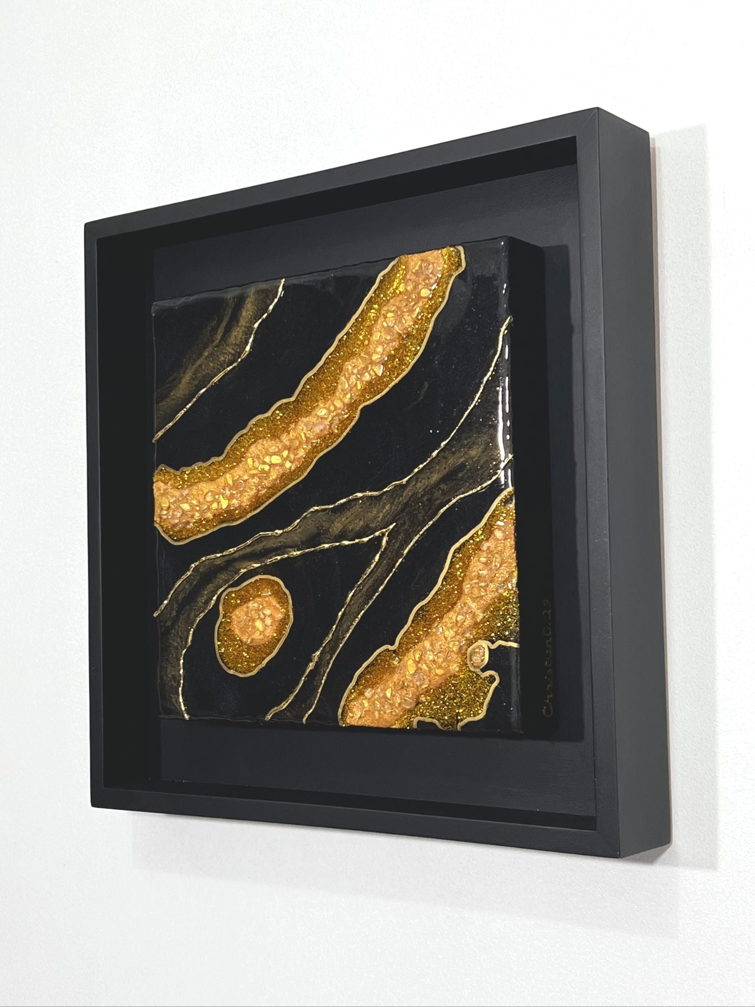 12" x 12" Black and Gold Resin Geode wall art in black wood frame.