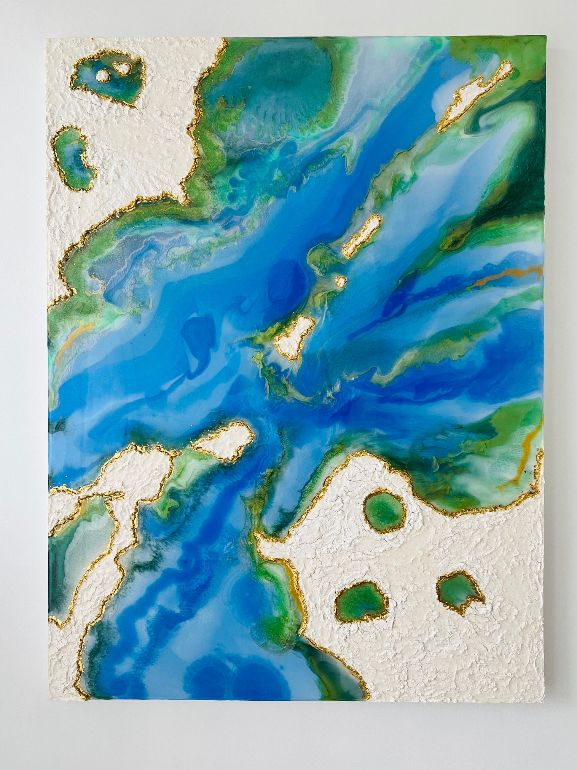 Resin flow art depicting clouds, water and ocean.