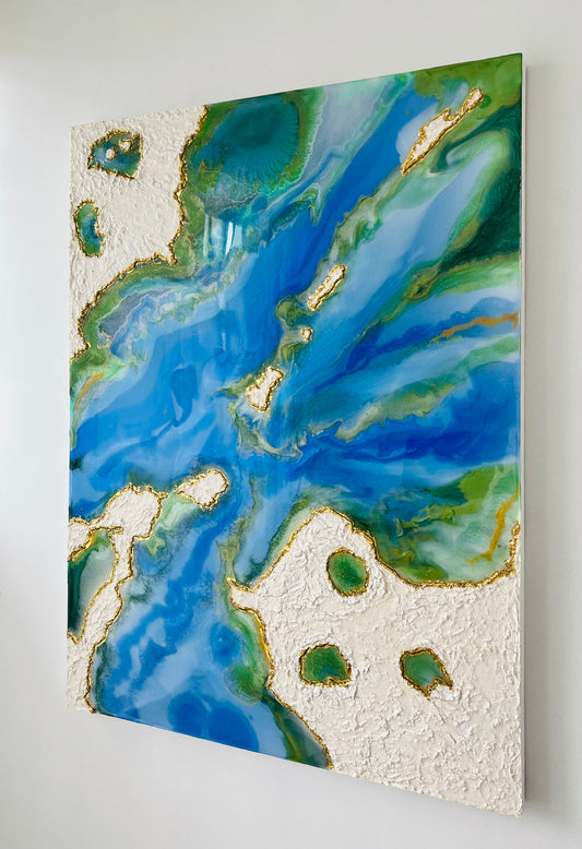 Resin flow art depicting clouds, water and ocean. 